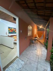 a room with a patio with a table and a bed at Hospedagem Morada Aguiar - casa e kitnet in Abraão +27 photos