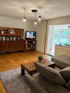 a living room with a couch and a tv at The Budim House in Berane