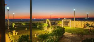 a park at dusk with the ocean in the background at Vacation home 32 D in Borg El Arab