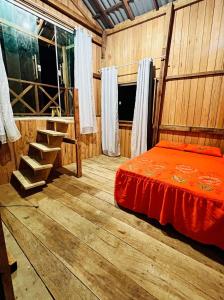 a bedroom with a bed and a wooden floor at Recanto Paraiso Tropical- Praia Ajuruteua in Bragança +5 photos