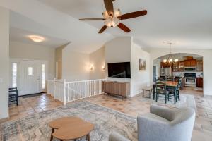 a living room with a ceiling fan and a dining room at Hot Tub and Game Room Family Retreat in Groveland! in Groveland