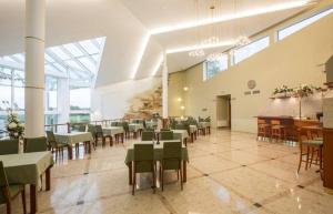 a dining room with tables and chairs in a building at Viesnīca Garden in Višķi