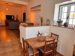 a kitchen and dining room with a table and chairs at Casa D' Oliveira in Castro Verde