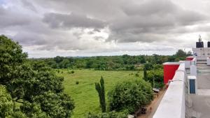 a view of a field from the balcony of a building at Fk homes executive studio with rooftop pool in Mtwapa