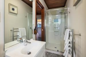 a bathroom with a sink and a shower at Harbour View Cottage Bay of Islands in Opua