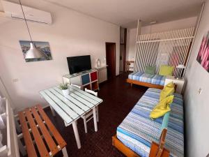a living room with a table and a couch at Residence Casa Pineta in Principina a Mare