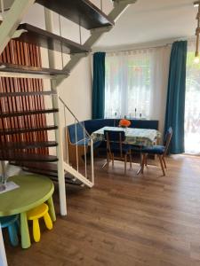 a living room with a staircase and a table at Napsugár Vendégház Tokaj-Rakamaz in Rakamaz