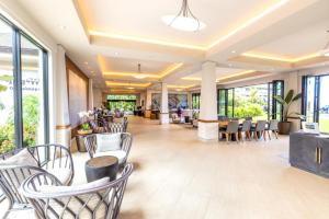 a lobby of a hotel with chairs and tables at The Whaler by KBM Resorts in Kaanapali