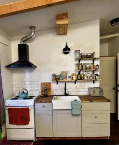 a kitchen with a white stove and a sink at Peaceful Gem in the Center of Silverton in Silverton