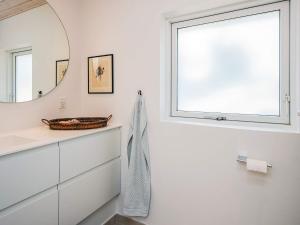 a bathroom with a mirror and a sink at 4 star holiday home in Blokhus-By Traum in Blokhus +63 photos