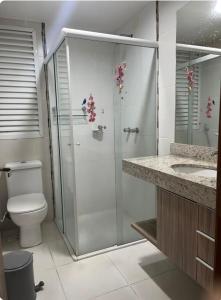 a bathroom with a shower with a toilet and a sink at Riviera Park Hotel in Caldas Novas
