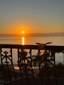 a sunset from the balcony of a resort at Casa Ilha Grande in Praia de Araçatiba