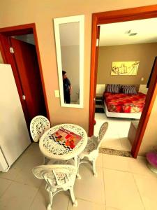 a table and chairs in a room with a bedroom at Riviera Park Hotel in Caldas Novas +14 photos