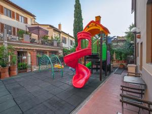a playground with a slide in a courtyard at Hotel Mia Cara & Spa in Florence