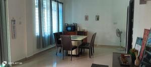 a dining room with a table and chairs at Green Tree Homestay in Miri