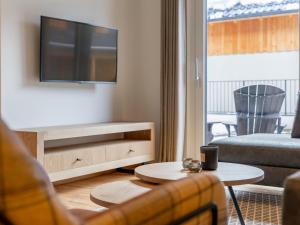 Televízia a/alebo spoločenská miestnosť v ubytovaní Mountain Chalet Dahoam