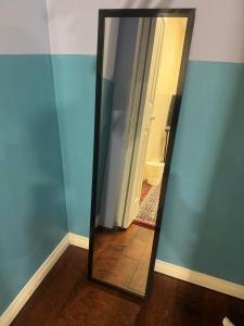 a mirror in a room with a hallway at Dunbar Guest Home close downtown Vancouver, UBC and store in Vancouver