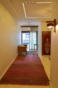 a hallway with a red rug on the floor at Appartement Nadine Fès in Fez +49 photos