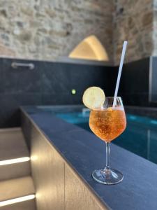 a drink sitting on a counter next to a swimming pool at Hotel Mia Cara & Spa in Florence