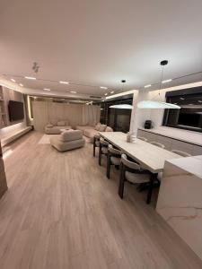 a large living room with a dining table and chairs at Villa Naléj in Mostar