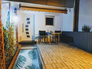 a room with a table and a pool of water at Wohnung Liana mit Blick zur Burg in Hechingen