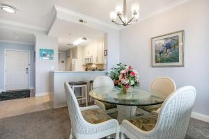 Un comedor con una mesa de cristal y sillas. en Luxe, Updated, Oceanfront Condo with Ground-Floor Patio, WiFi & Shared Pool, en Amelia Island