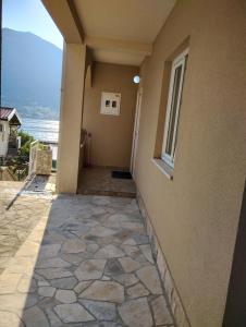 a walkway leading to a building with a window at Apartment Bay View in Kotor