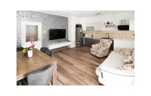 a living room with a dining table and a kitchen at Two-Bedroom Holiday Home In Sibenik in Šibenik