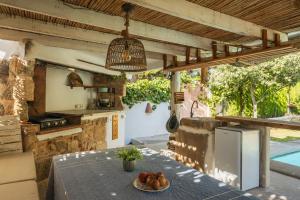 an outdoor kitchen with a table with fruit on it at Latidos del mar in Denia