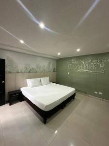 a bedroom with a large bed in a room at Hotel Portofino in San Andrés
