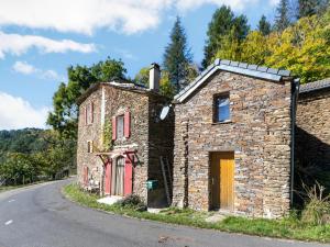 an old stone house on the side of a road at Cevennes Stone Retreat in Saint-Germain-de-Calberte