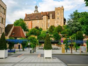 a large brick building with a tower on top at Holiday Home in Teilhet near Chateau Rocher in Teilhet