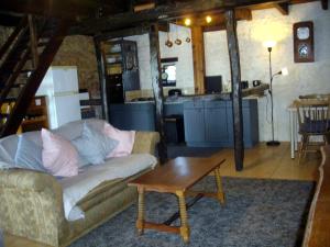 a living room with a couch and a table at Holiday Home in Teilhet near Chateau Rocher in Teilhet