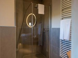 a bathroom with a shower with a sink and a mirror at Vacation House near Tournai in Award-Winning Park in Antoing +31 photos