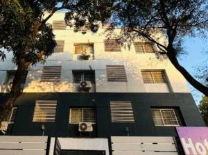 a black and white building with windows and air conditioning at OYO 77138 Shree Apartments in Khadki