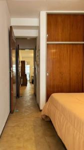 un couloir menant à une chambre avec un lit dans l'établissement Ayacucho loft, à Córdoba
