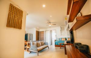 a living room with a couch and a bedroom at Santamar Penthouse G 306 in Akumal