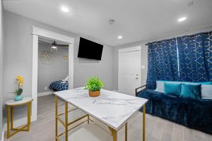 a living room with a table and a couch at Bright and Airy 2BR with King Bed Free Parking and Pool in Houston