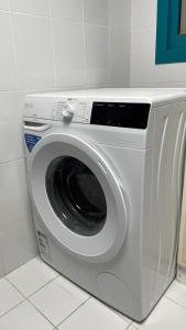 a washing machine sitting in a kitchen at Book A bed Hostel in Dubai