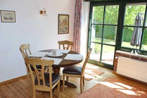 a dining room with a table and chairs and a window at Casa Clara in Kleve
