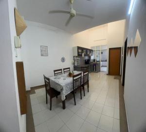 a kitchen and dining room with a table and chairs at Homestay Dmickey in Sungai Petani