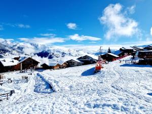 a snow covered mountain with houses and buildings at Charmant Appartement Ski-In à La Plagne - 6 Pers. - FR-1-755-41 in Aime La Plagne +1 photo