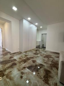 an empty room with white walls and concrete floors at Квартира премиум класса у побережья 80кв in Chornomorsk +11 photos