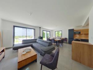 a living room with a couch and a table at Villa neuve aux Rousses, proche centre, jusqu'à 12 personnes - FR-1-834-5 in Les Rousses