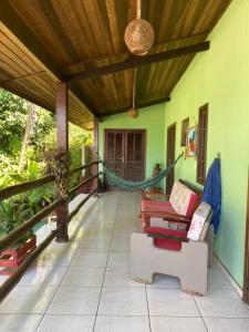 a porch of a house with a hammock at Suites Casa K in Ubatuba +32 photos