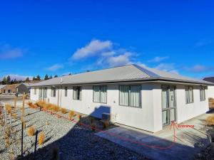 a house with a red tape around it at 18 Jimmys Apartment in Lake Tekapo