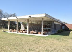a pavilion with chairs and tables in a field at El Sueño in Salta