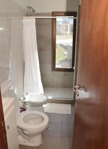 a bathroom with a toilet and a window at El Sueño in Salta
