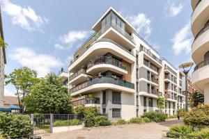an apartment building with balconies on a city street at Luxury apartment near Paris in Bois-Colombes