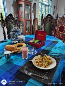 a table with a plate of food and bread on it at Buriti EcoH RNT56521, via Termales Santa Rosa de Cabal in Santa Rosa de Cabal